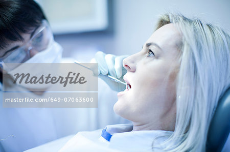 Close up of dentist checking patients teeth