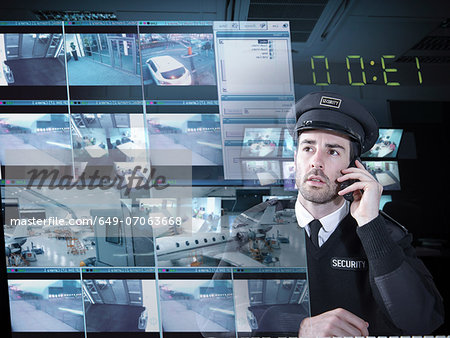 Security guard monitoring camera visuals on interactive screen