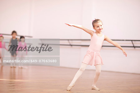 Young ballerina posing in class