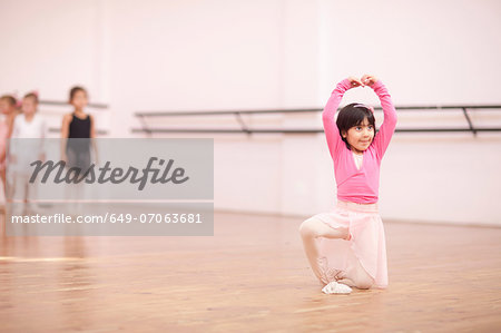 Young ballerina posing in studio