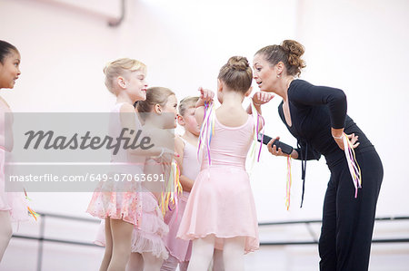 Teacher and enthusiastic young ballerinas