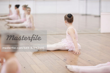 Young ballerina looking at mirror