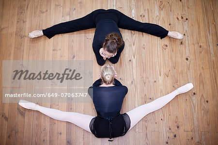Teacher practicing pose with ballerina
