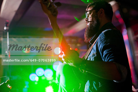 Man playing guitar in nightclub