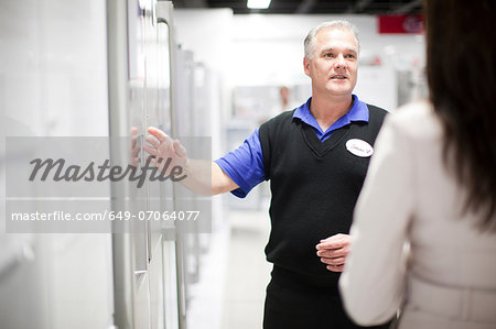 Woman looking at refrigerator in showroom