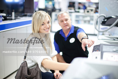 Young woman and salesman in showroom