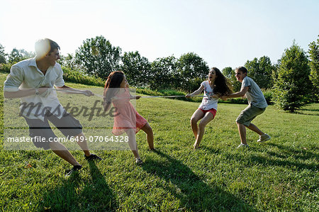 Group of young adults playing tug of war Group of young adults playing tug of war