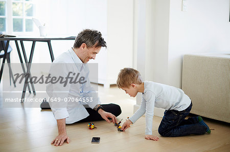 Father and son playing with toys