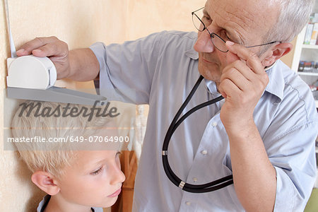 Doctor measuring boy's height