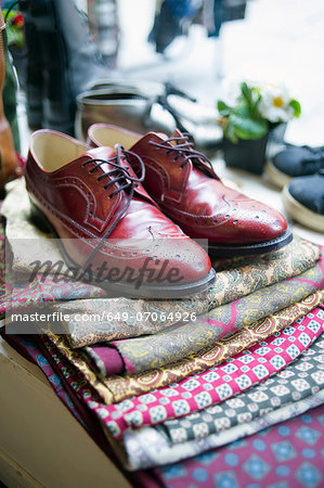 Vintage men's shoes on top of pile of fabric