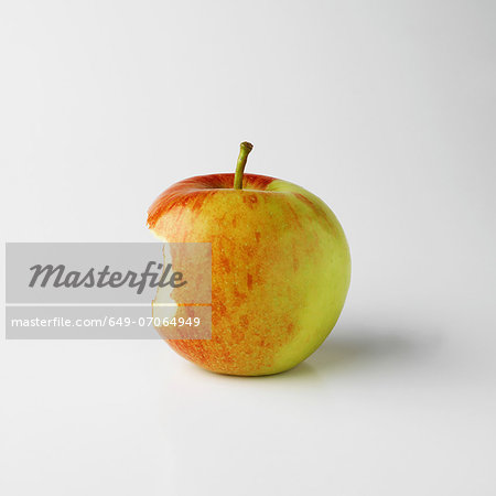 One apple on white background with bite mark
