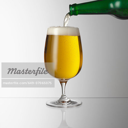 Pouring beer into glass Pouring beer into glass