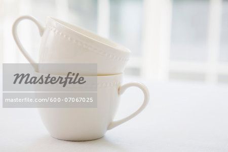 Stacked white porcelain teacups, studio shot