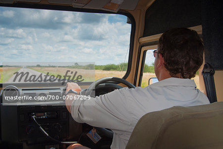 Man driving vehicle on road to Etosha, Namibia, Africa