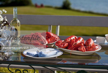 Platters of Cooked Lobsters on an Outdoor Table; White Wine