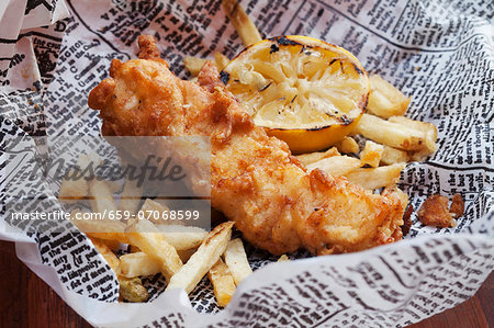 Fish and Chips with Lemon on Newspaper