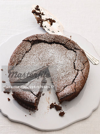 Chocolate cake dusted with icing sugar and sliced