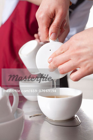 Pouring tea into a cup