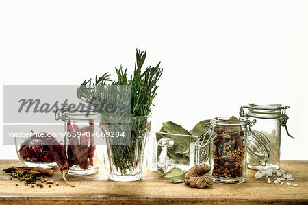 Sill life with assorted herbs and spices in glass containters