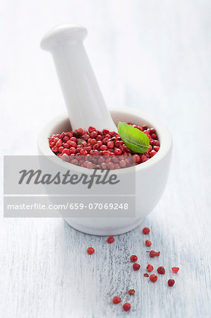 Pink peppercorns in a mortar