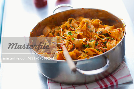 Pappardelle bolognese in a saucepan