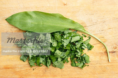 A wild garlic leaf and chopped wild garlic A wild garlic leaf and chopped wild garlic