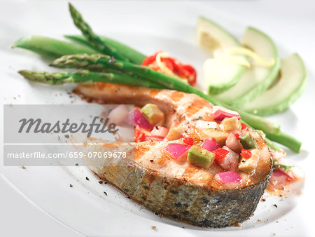 Salmon steak with avocado salsa and green asparagus