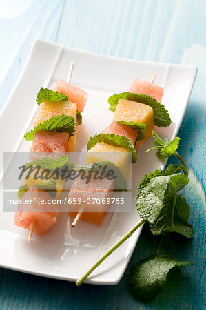 Melon skewers with mint leaves