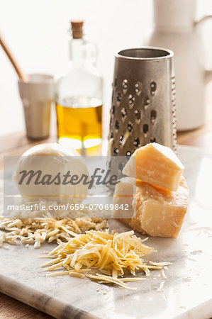 Assorted types of cheese, grated Assorted types of cheese, grated