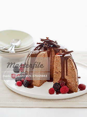 Ice cream bombe with chocolate sauce and fresh berries