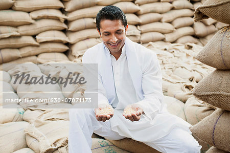 Man showing wheat grains, Anaj Mandi, Sohna, Gurgaon, Haryana, India