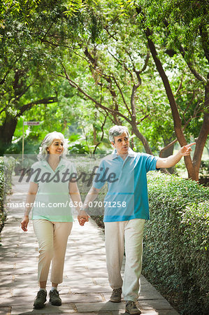 Mature couple walking in a park, Lodi Gardens, New Delhi, India