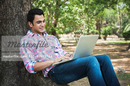 Man using a laptop in a park, Lodi Gardens, New Delhi, Delhi, India