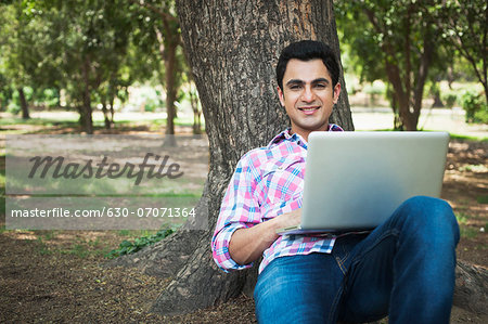 Man using a laptop in a park, Lodi Gardens, New Delhi, Delhi, India