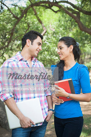 Friends standing in a park and smiling, Lodi Gardens, New Delhi, Delhi, India