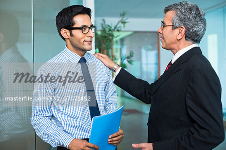Boss talking with his employee in an office