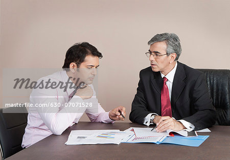 Business executives discussing a report