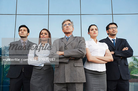 Business people standing together with their arms crossed