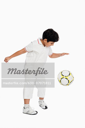 Boy playing with a football