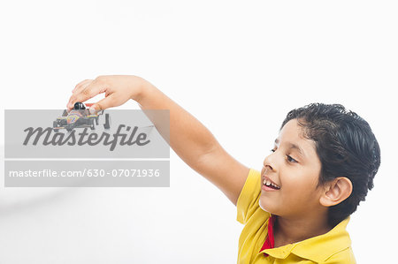 Boy playing with a toy car