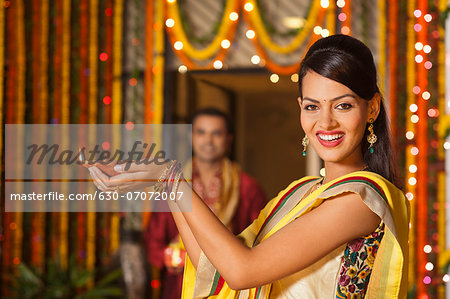 Woman holding an oil lamp on Diwali Woman holding an oil lamp on Diwali