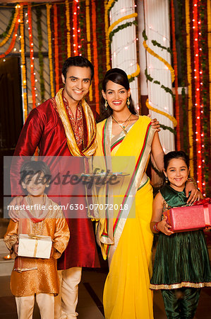 Family holding gifts on Diwali