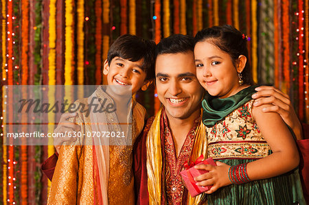 Man hugging his children on Diwali