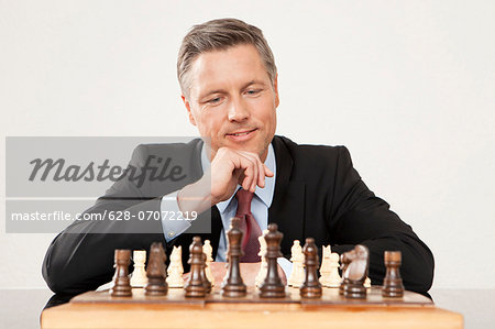 Businessman playing chess