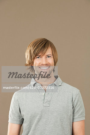 Smiling man in gray polo shirt