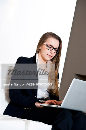 Teenage girl working on laptop