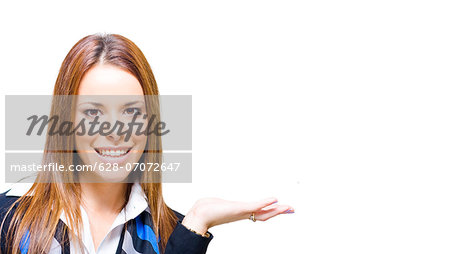 Young brunette businesswoman raising her hand