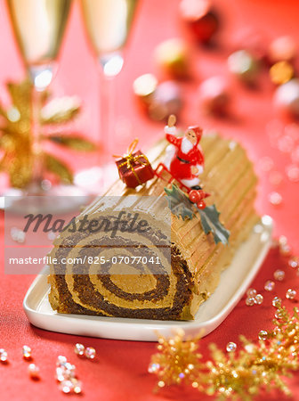 Christmas coffee log cake decorated with Santa Claus