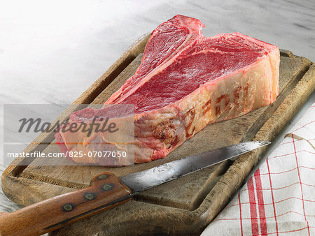 Raw T-bone steak on a chopping board
