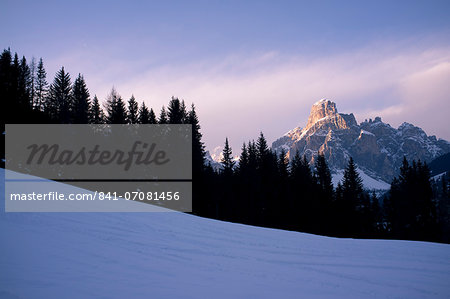 The last run, a view of Sassongher mountain at sunset from a piste at Alta Badia ski resort, Dolomites, South Tyrol, Italy, Europe